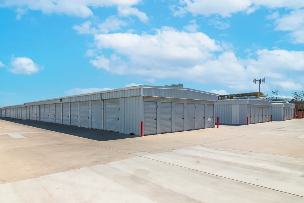 Drive-up storage units with roll-up doors and wide concrete access area